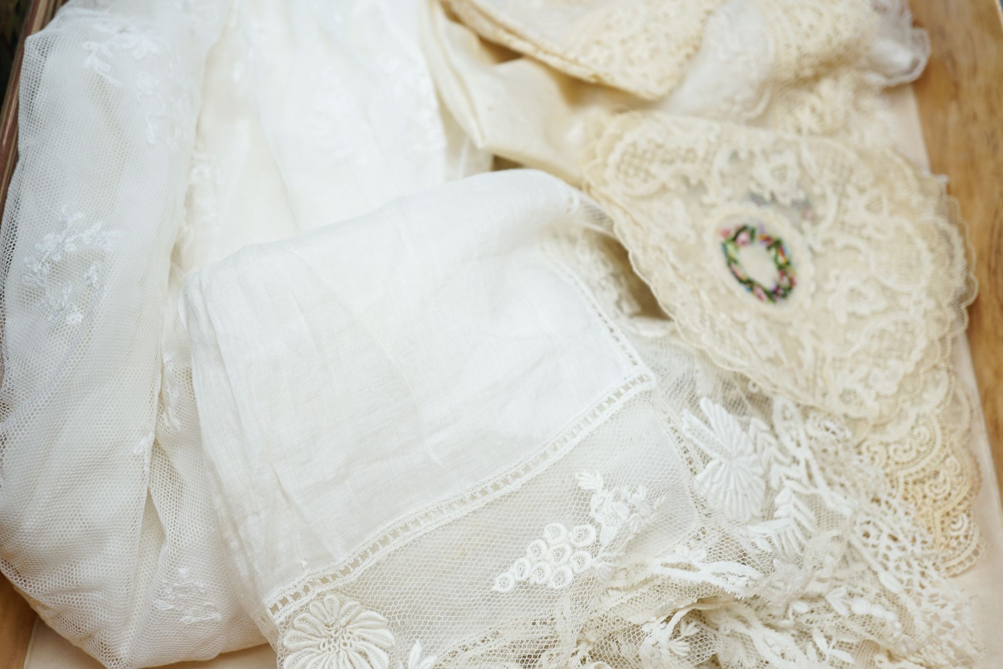 Two early 19th century, finely white worked lace hankies, various sets of lace mats and a lace baby dress, Hankies 40 cms x 40 cms.